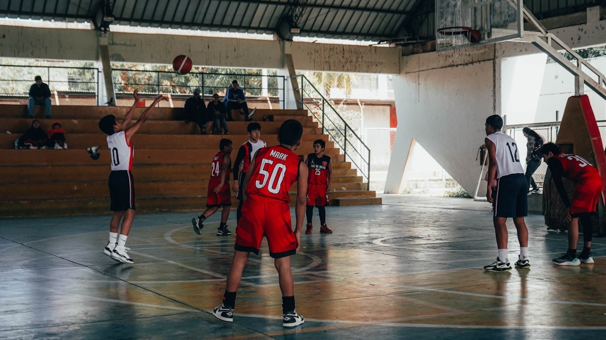 A group of young men playing a game of basketball